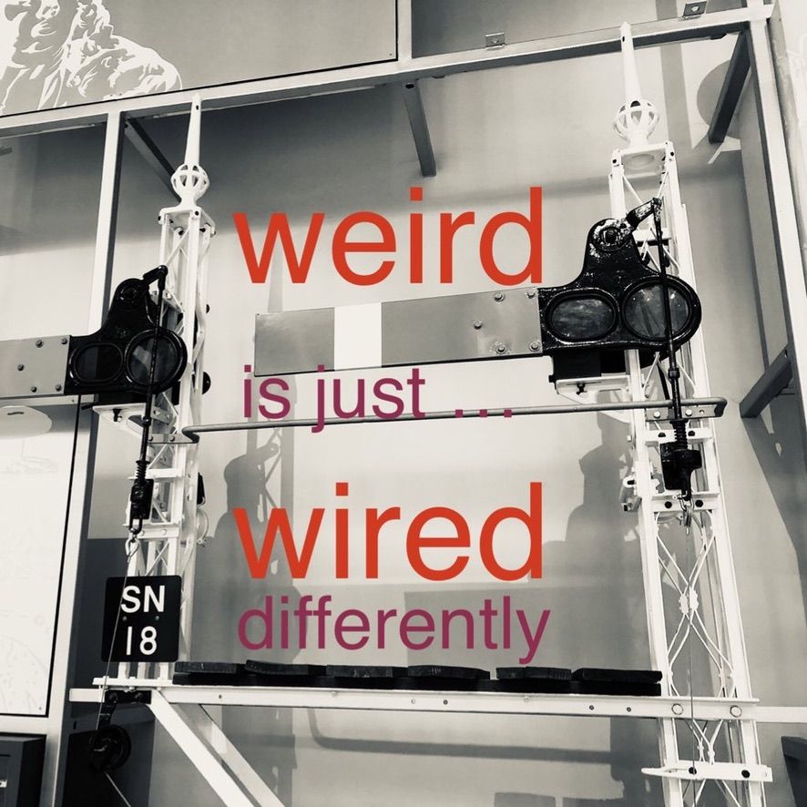 Weird is just … wired differently. This text appears over a monochrome photograph of the bracketed semaphore home signals SN 18 and SN 11, which are displayed in the main  hall of the National Museum of Scotland.